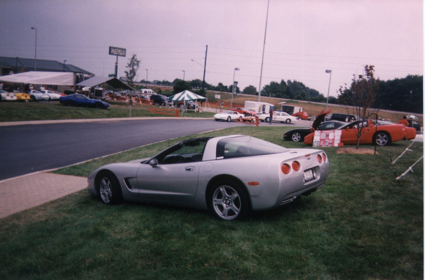 Rear photo of Dave's C5 on the lawn, with spectators and the parking lot full of Vettes 