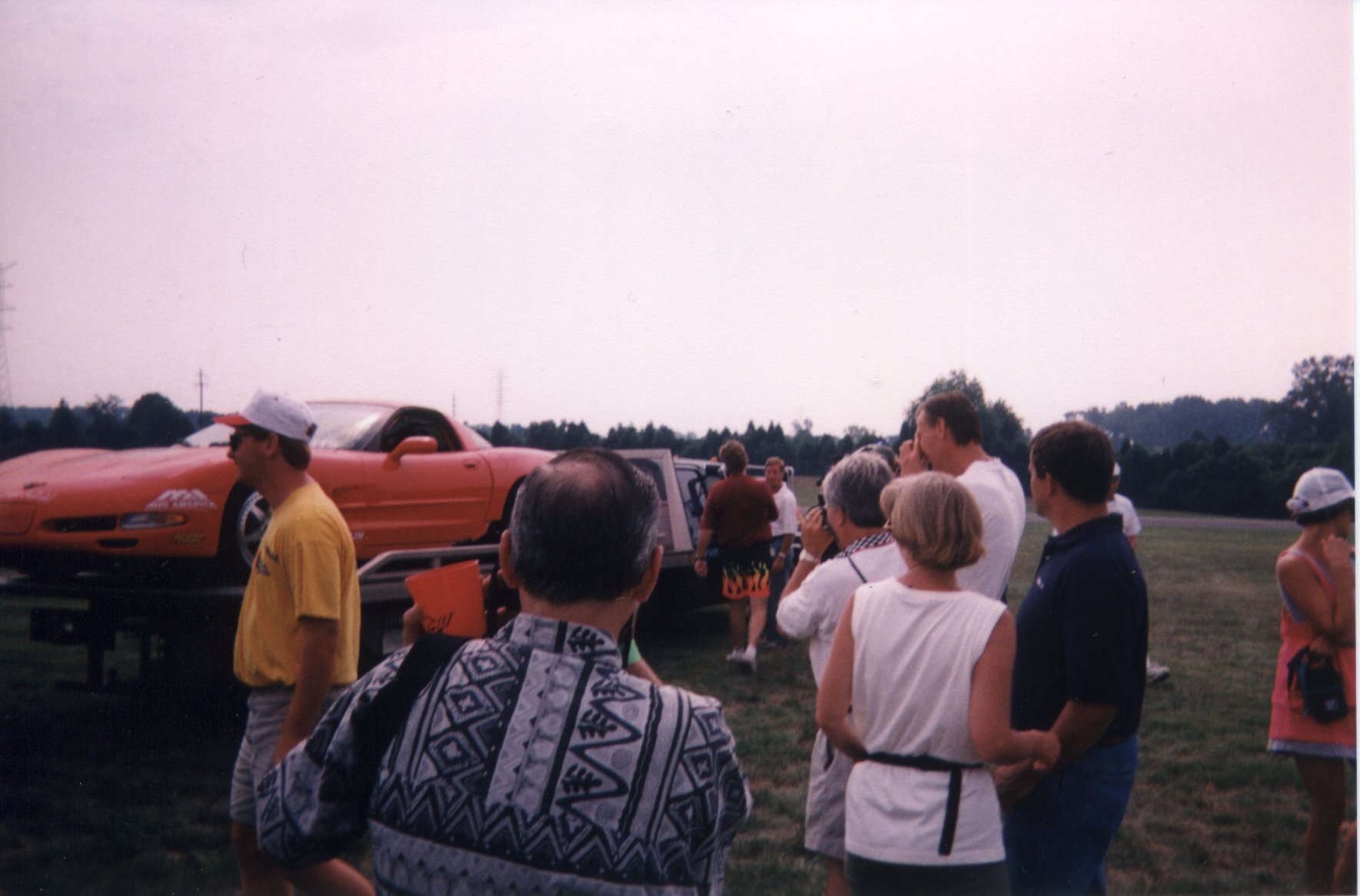 Doug Rippie loading the crashed car onto a flatbed, spectators snapping photos everywhere.